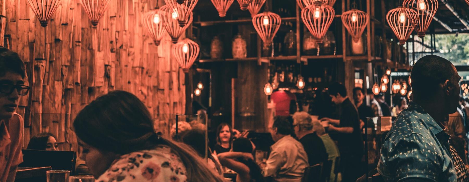 a group of people in a room with lanterns