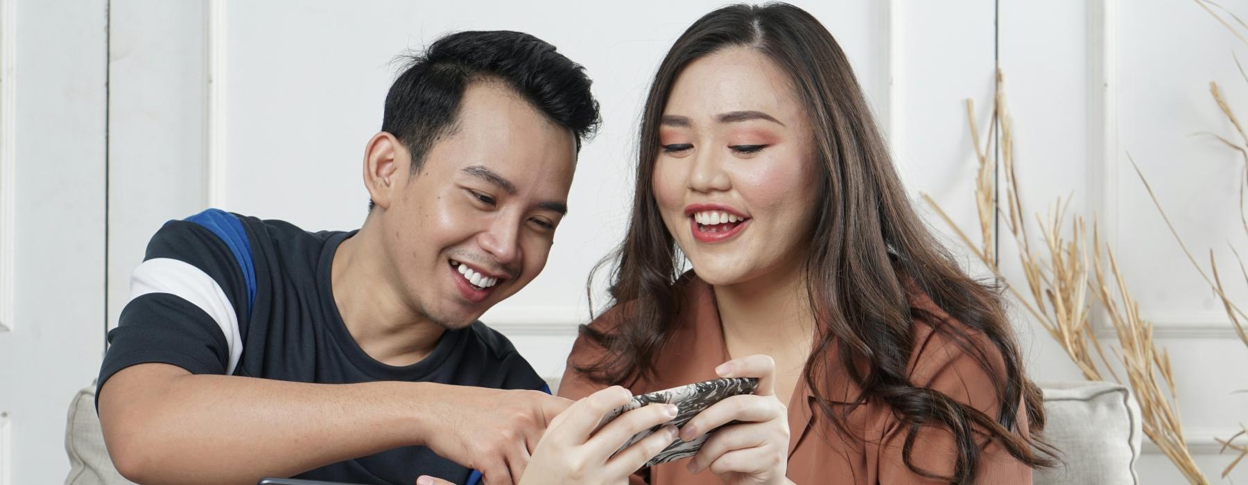 a man and woman playing a card game